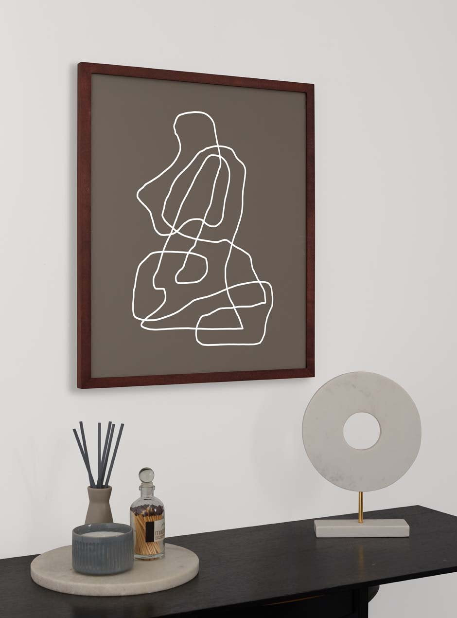 dark stained thin wooden frame holding abstract painting hung above table with various small objects