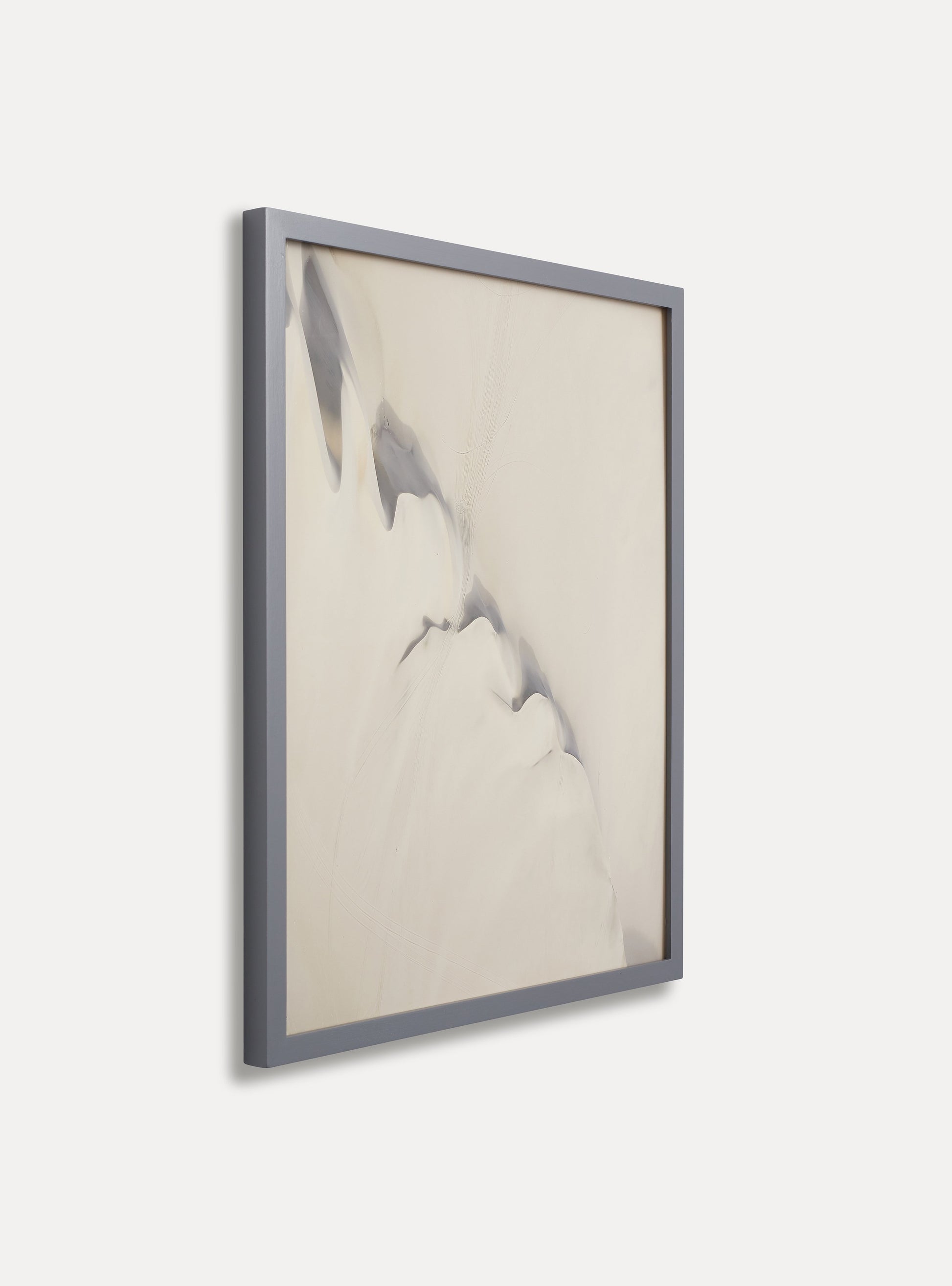 Side photo of a wooden picture frame on an off-white wall