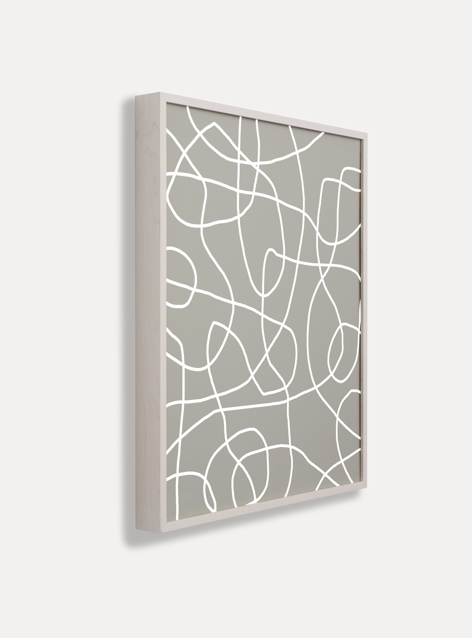 Side photo of a wooden picture frame on an off-white wall