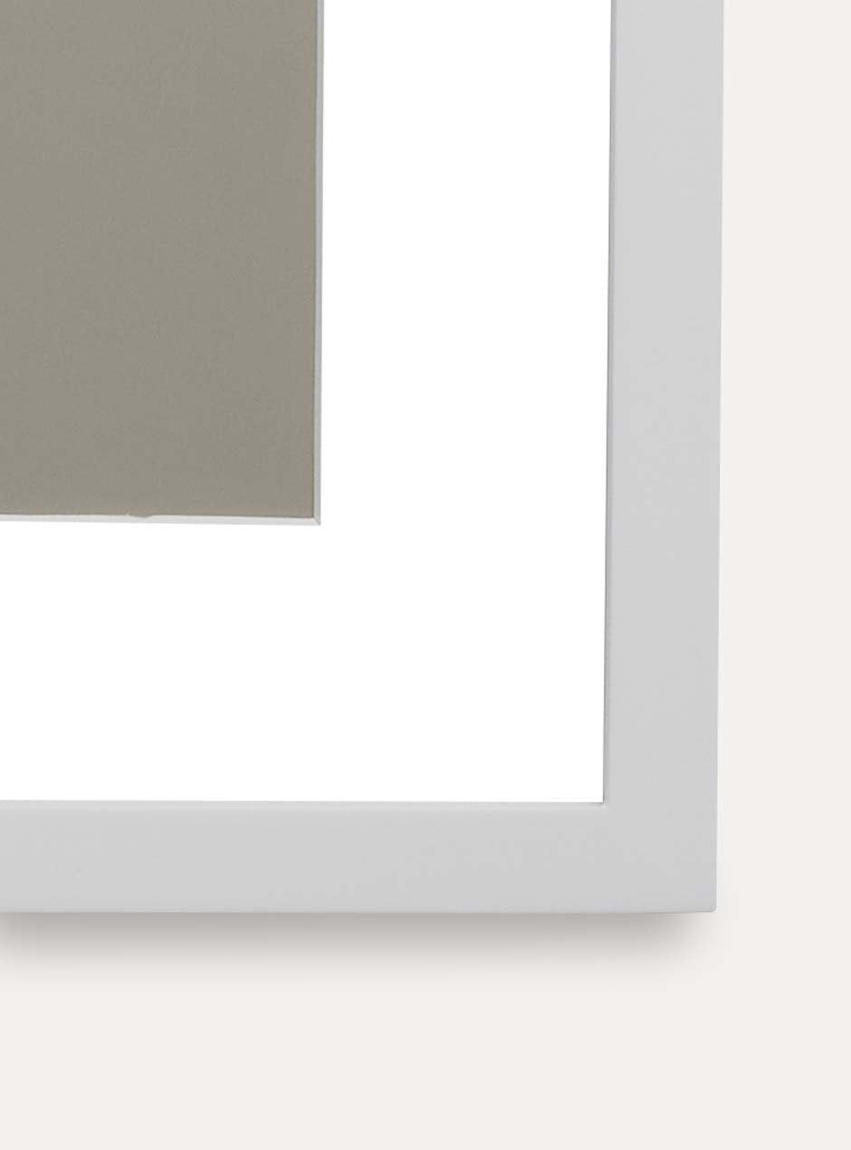 Close up of corner of white frame holding abstract art