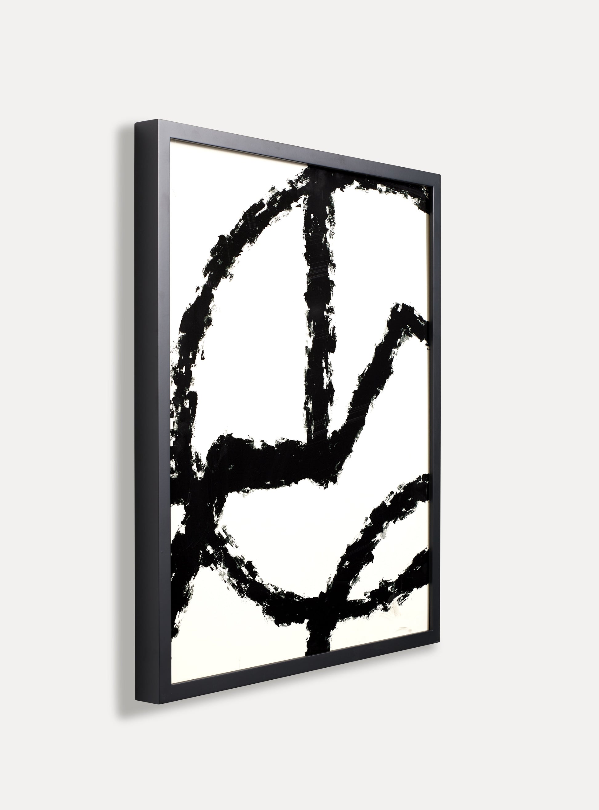 Side photo of a wooden picture frame on an off-white wall