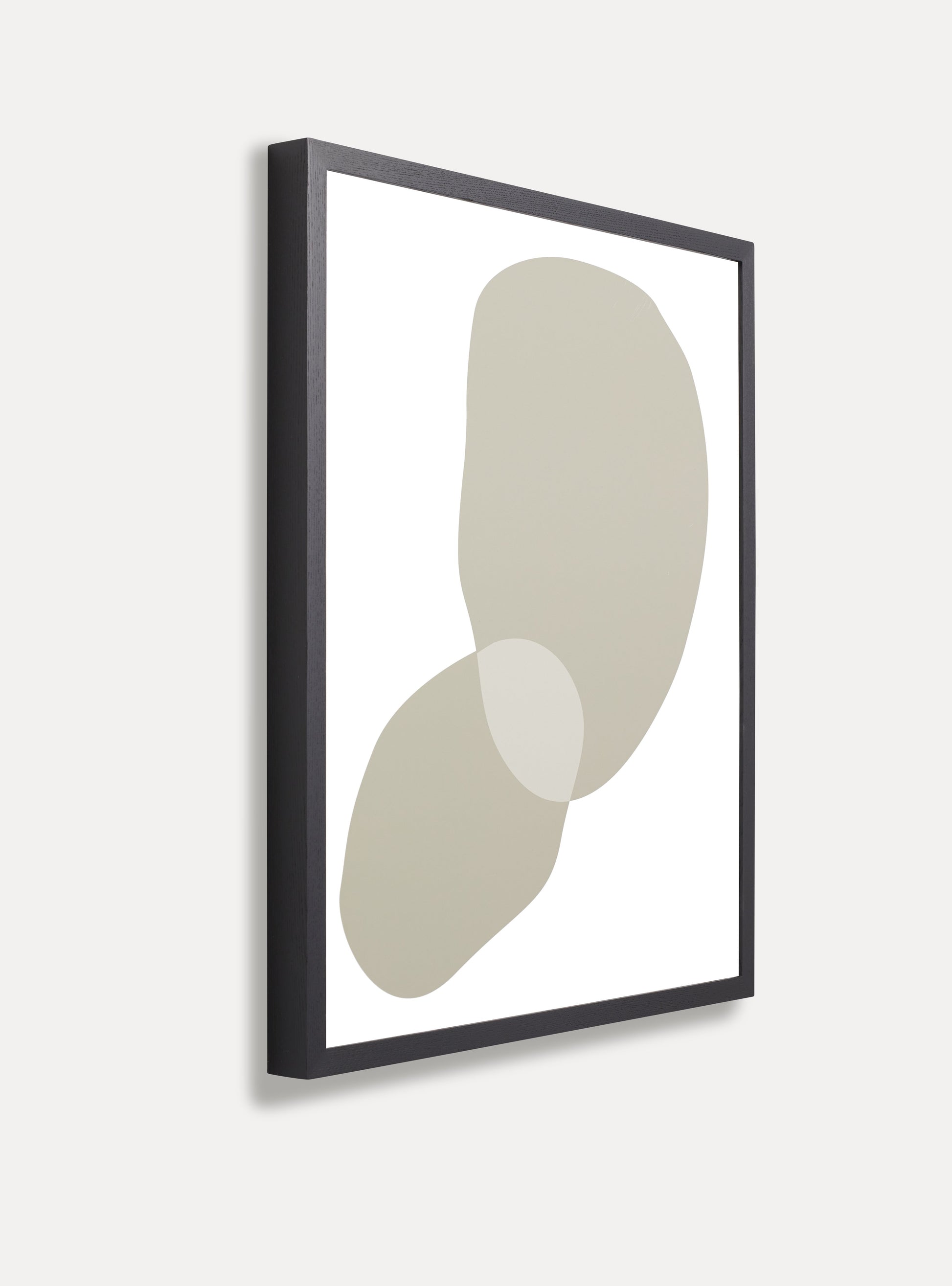 Side photo of a wooden picture frame on an off-white wall