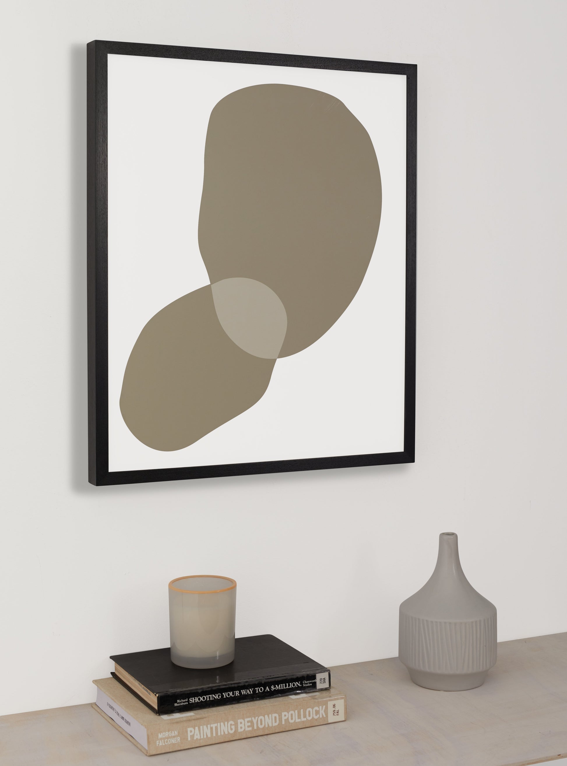 Photograph of a frame in a home with a table underneath showing various items