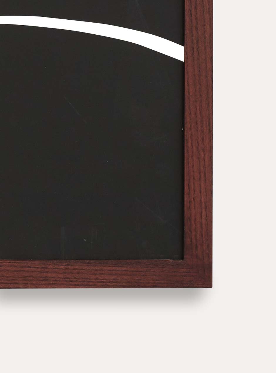 close up of corner of dark stained thin wooden frame holding abstract painting 
