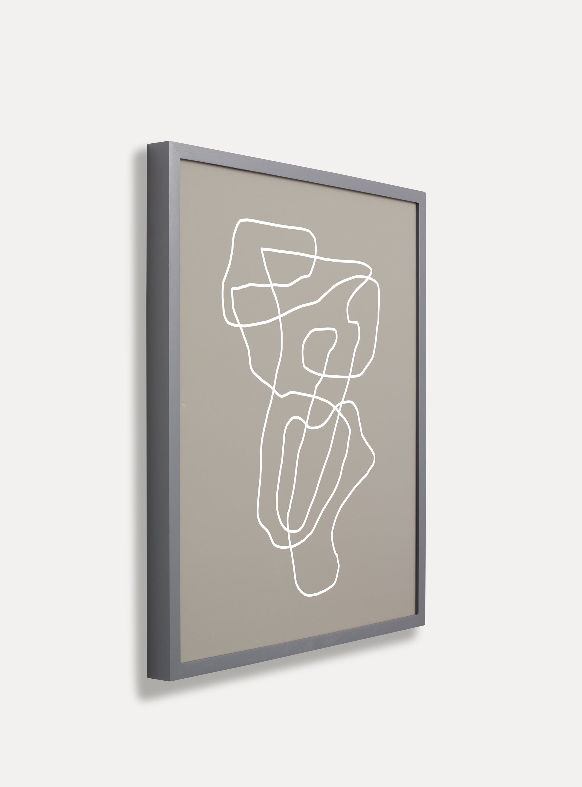 Side photo of a wooden picture frame on an off-white wall