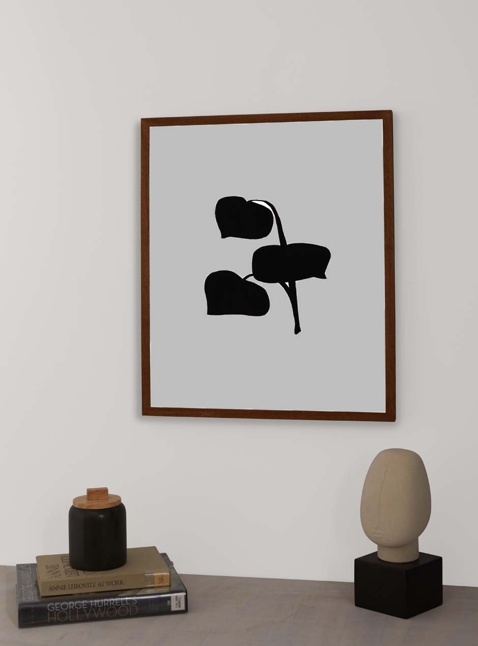thin wooden frame hung up above table with various objects
