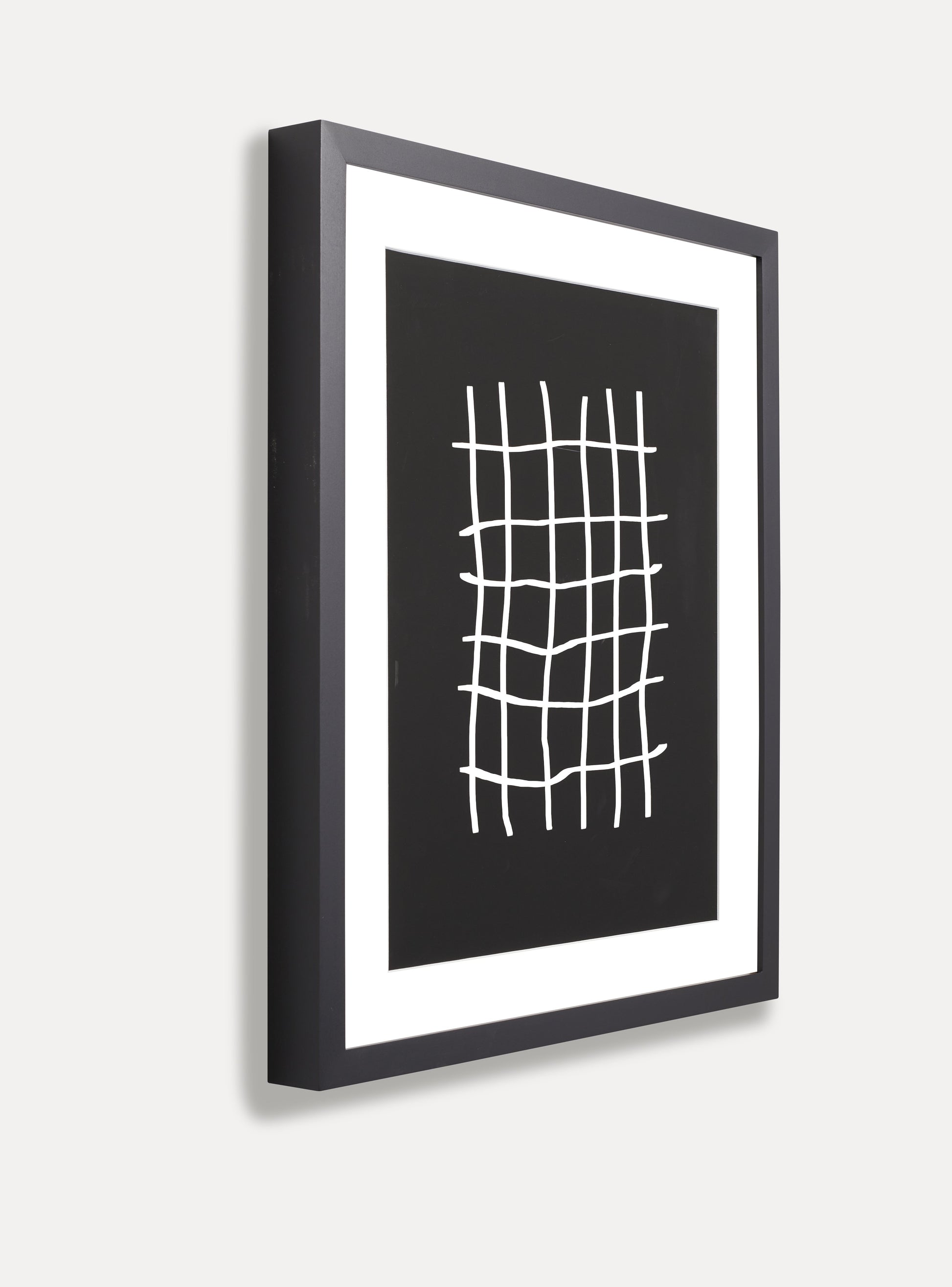 black solid maple frame with white matboard and black and white abstract art resembling a pound sign multiple times