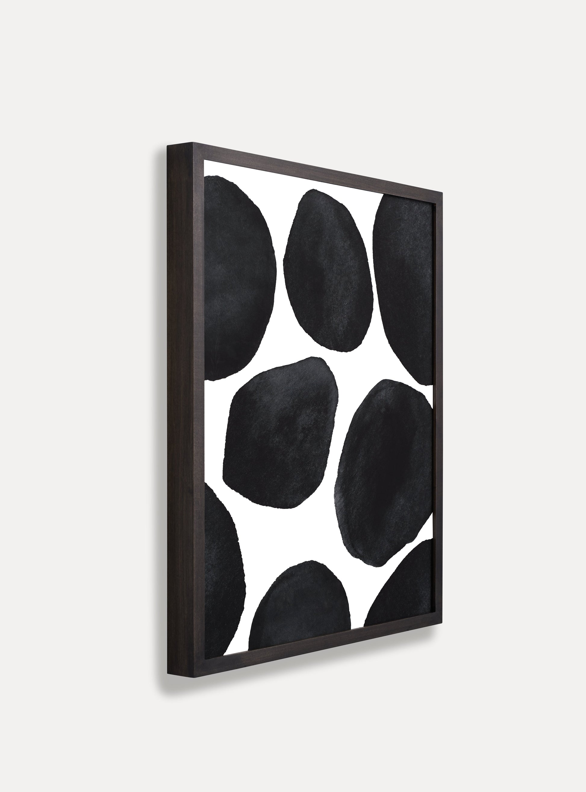 Side photo of a wooden picture frame on an off-white wall