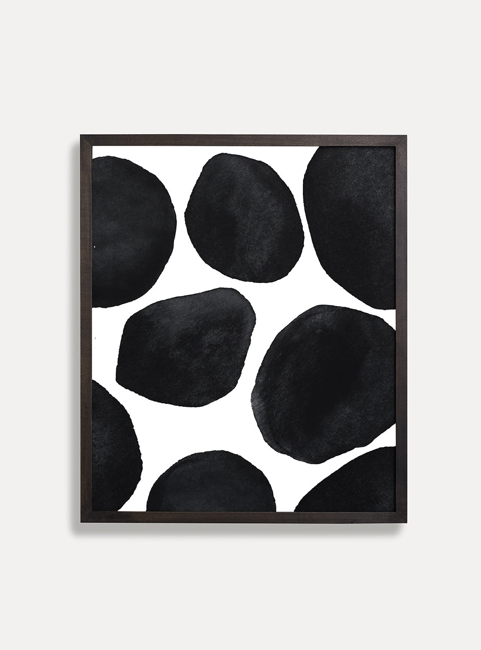 black abstract dots on white background in black frame on white wall