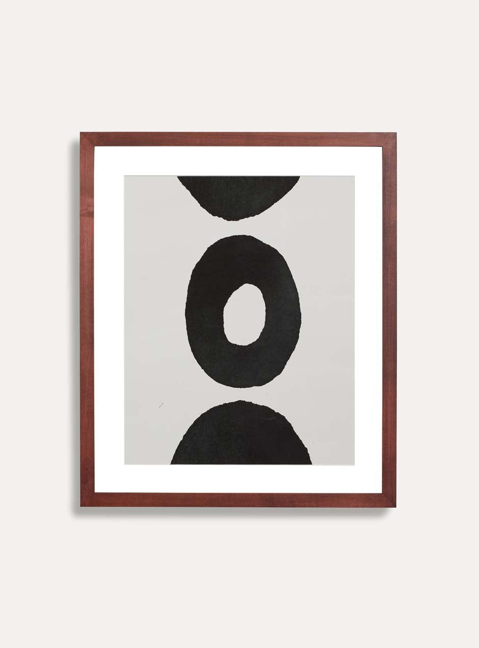 maple wooden frame with abstract circle image inside hung white wall