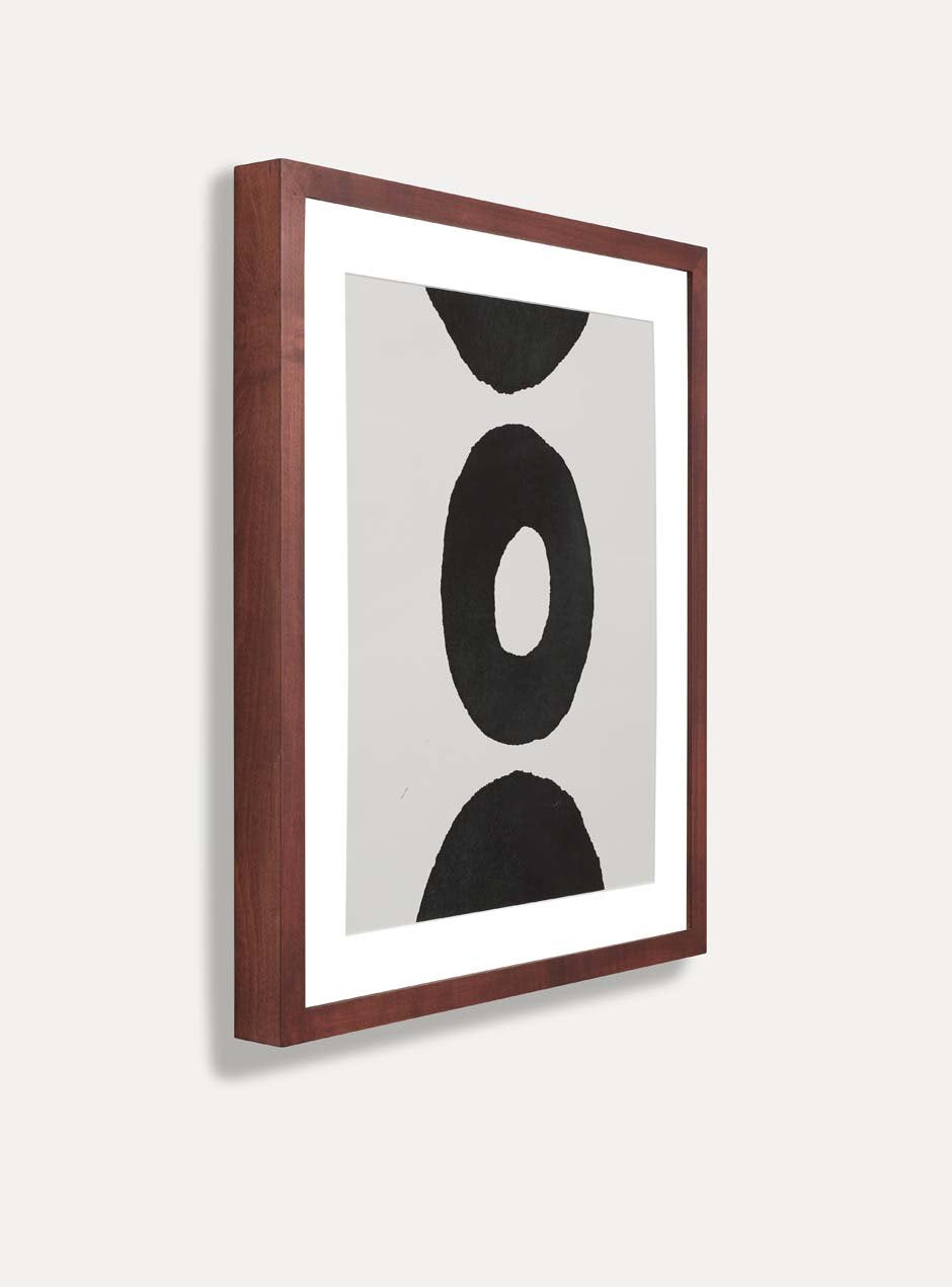 side view maple wooden frame with abstract circle image inside hung white wall