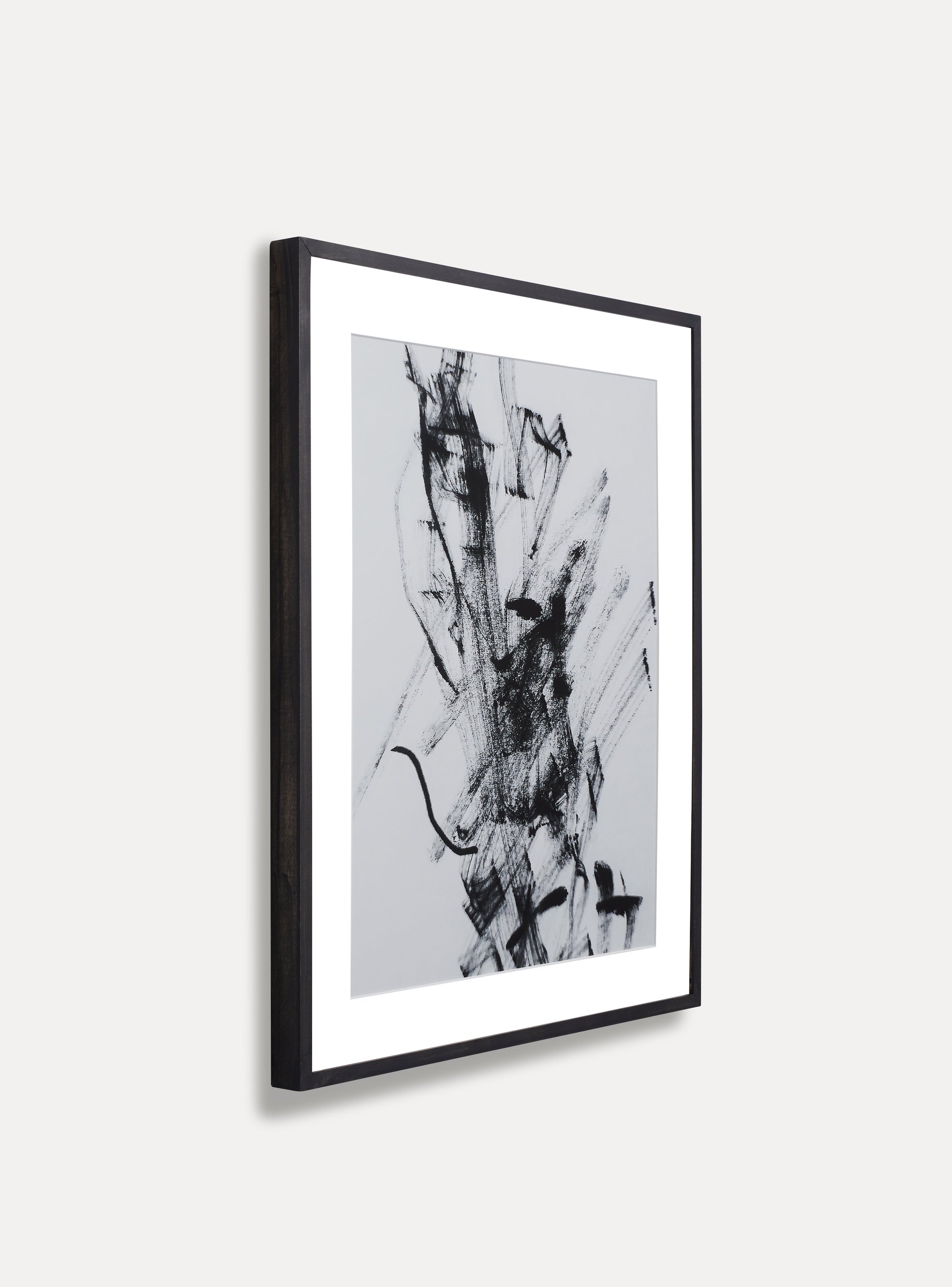 Side photo of a wooden picture frame on an off-white wall