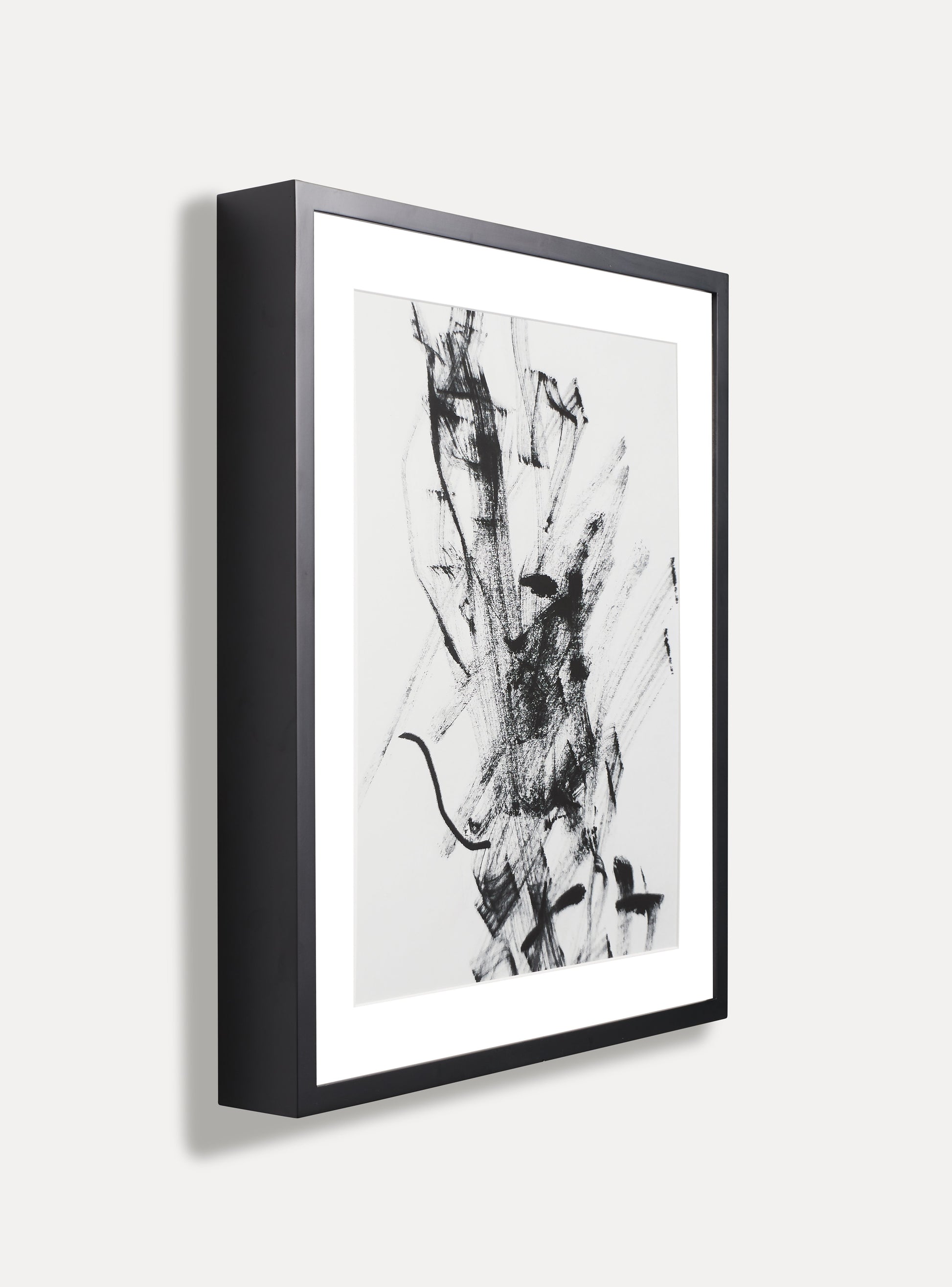 Side photo of a wooden picture frame on an off-white wall
