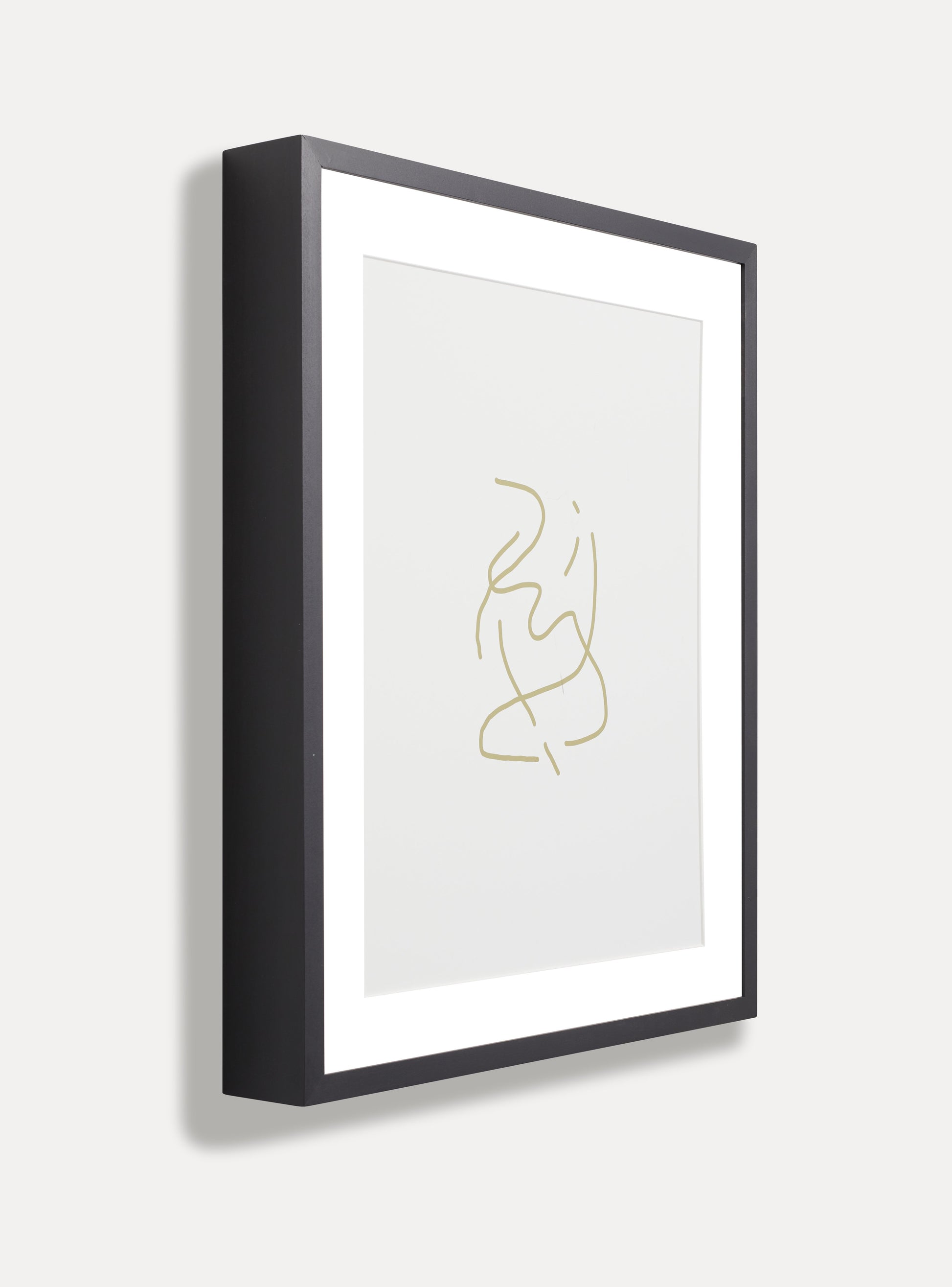 Side photo of a wooden picture frame on an off-white wall