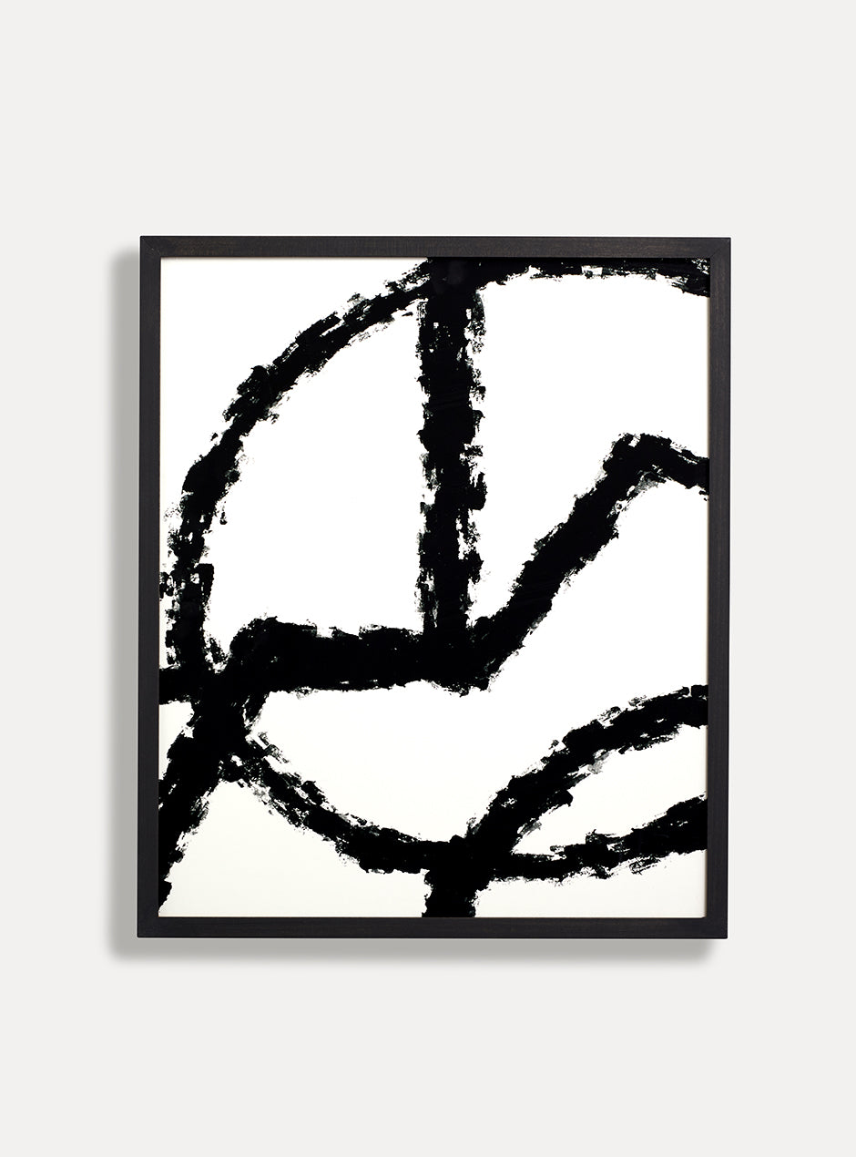 black and white abstract print in black frame on white wall