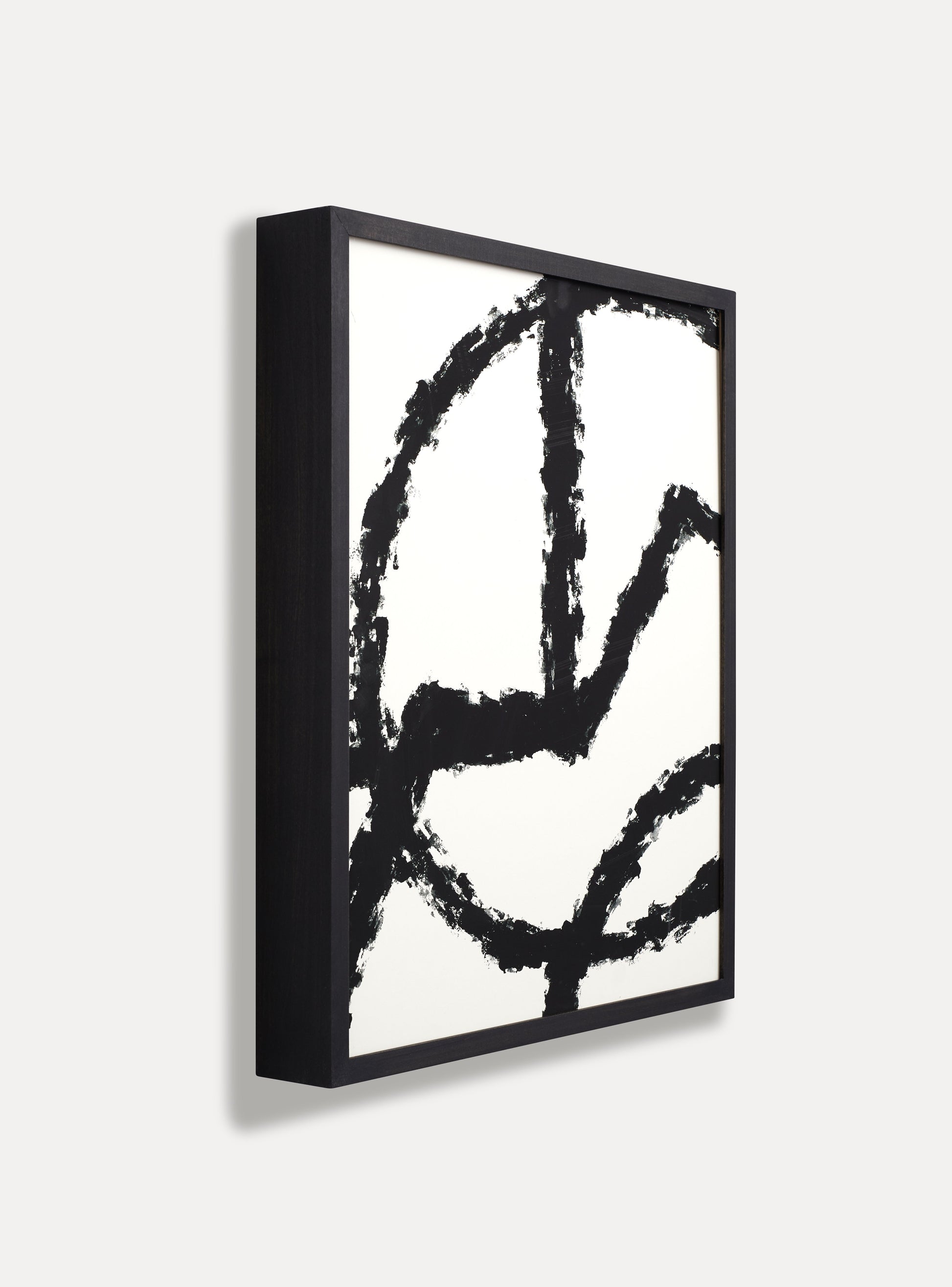 Side photo of a wooden picture frame on an off-white wall