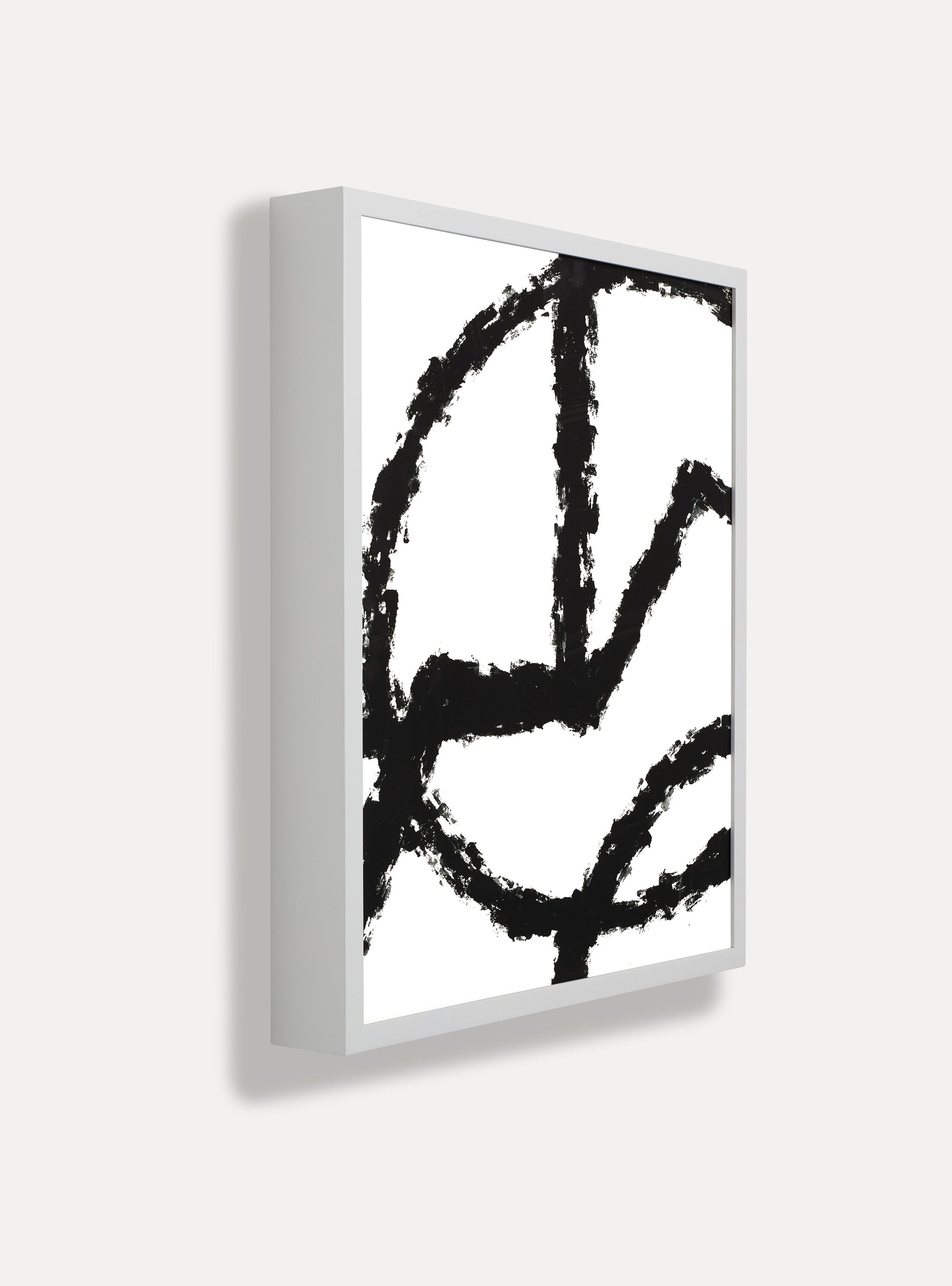 Side photo of a wooden picture frame on an off-white wall