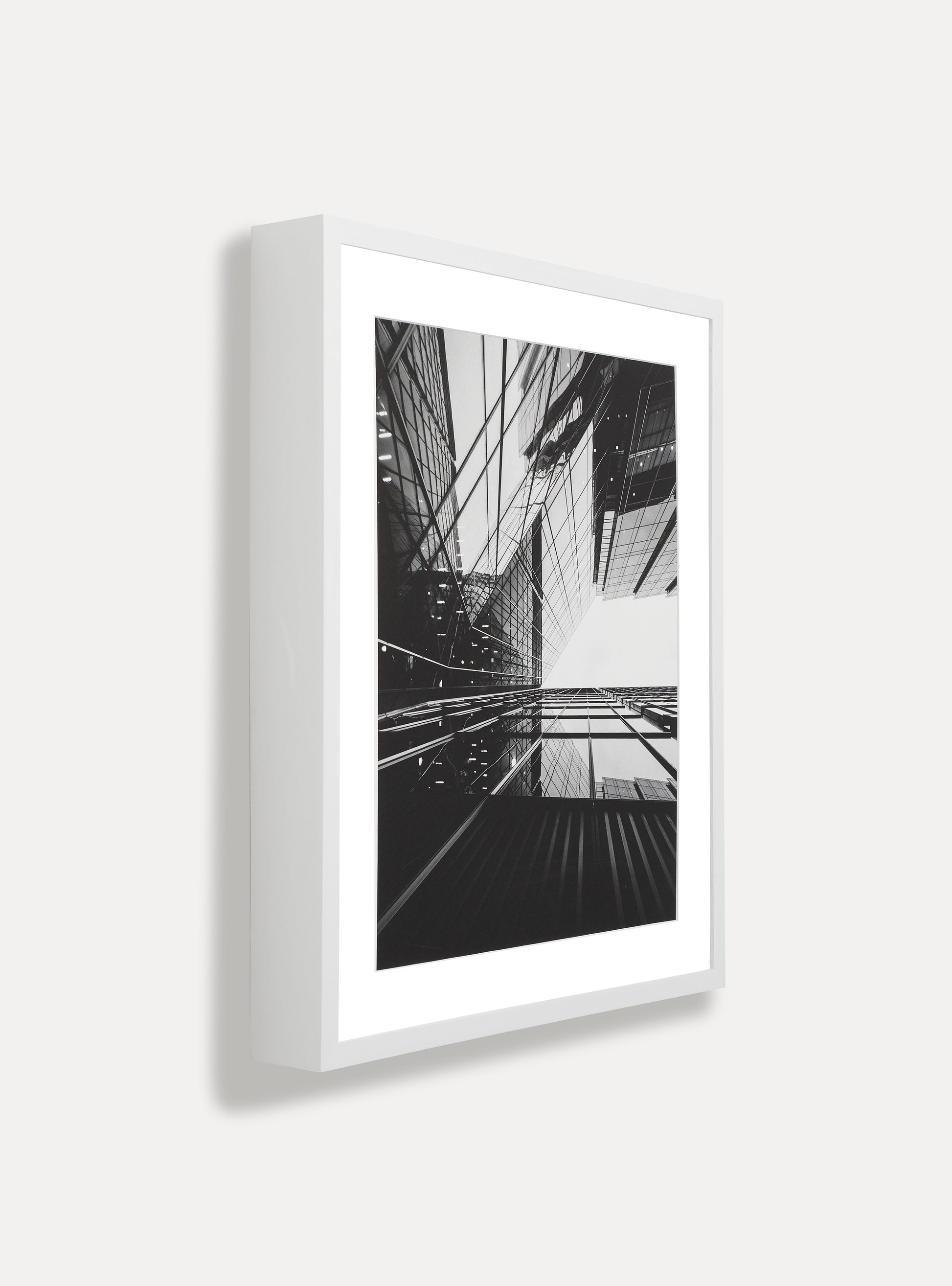 Side photo of a wooden picture frame on an off-white wall