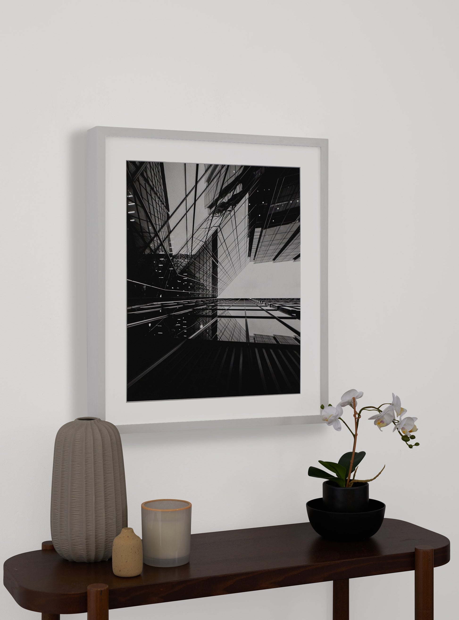 Photograph of a frame in a home with a table underneath showing various items
