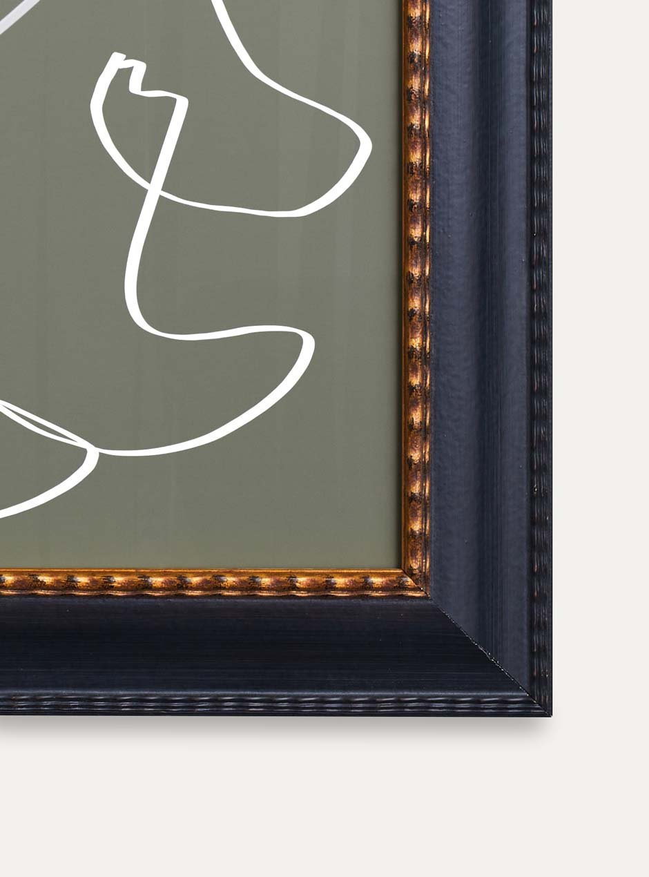 close up of corner of black frame with gold inner detailing holding abstract art