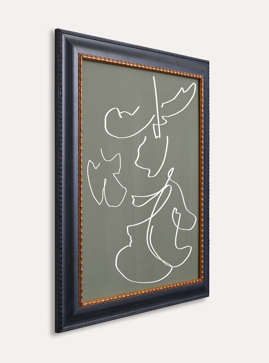 side view black frame with gold inner detailing holding abstract art