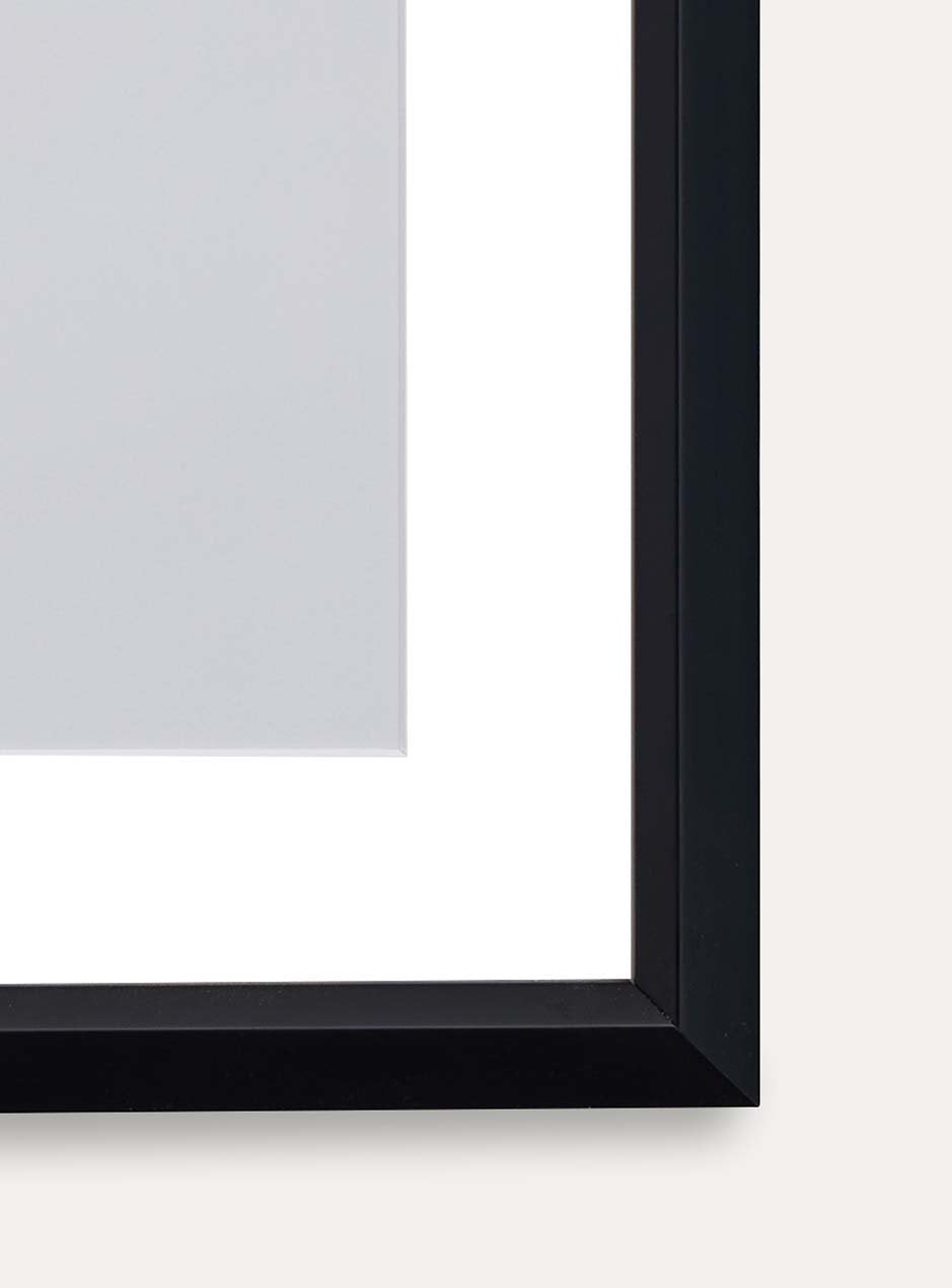 corner view of abstract circle on white background with black frame and white matting