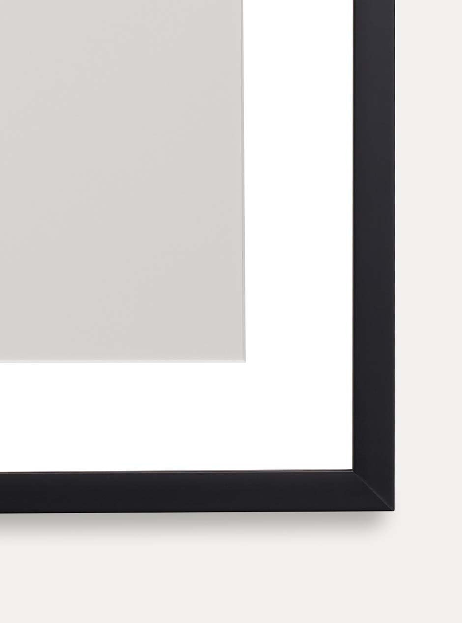 close up of corner of thin black frame holding abstract art
