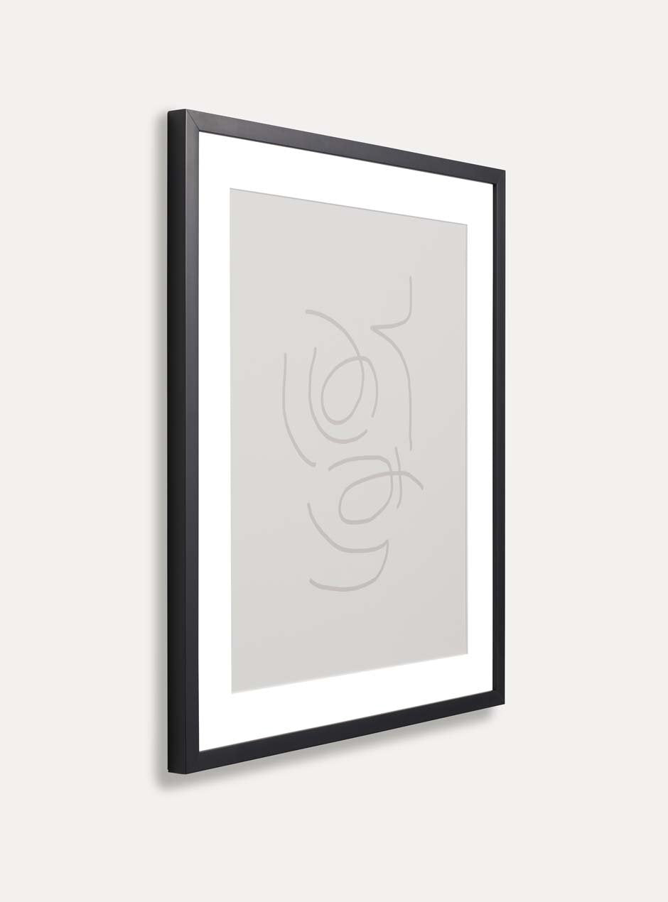 side view of thin black frame holding abstract art