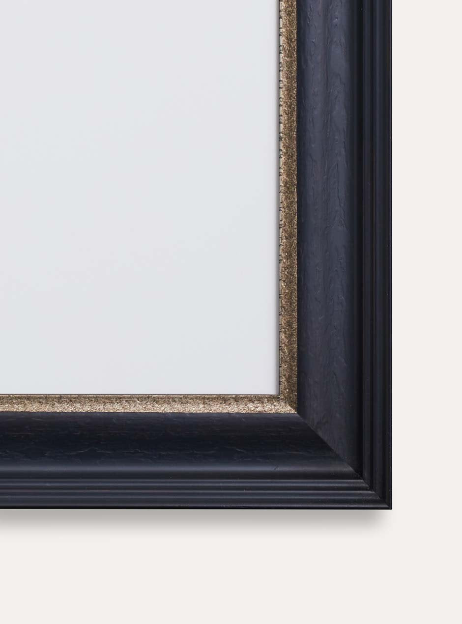 close up corner of black frame with gold inner detailing