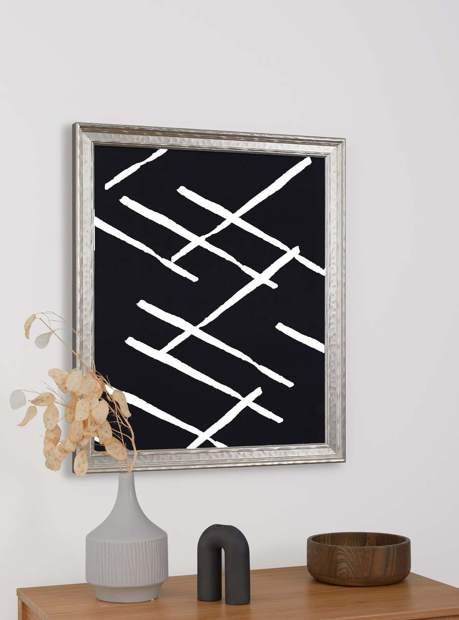 silver hammered frame hung in home