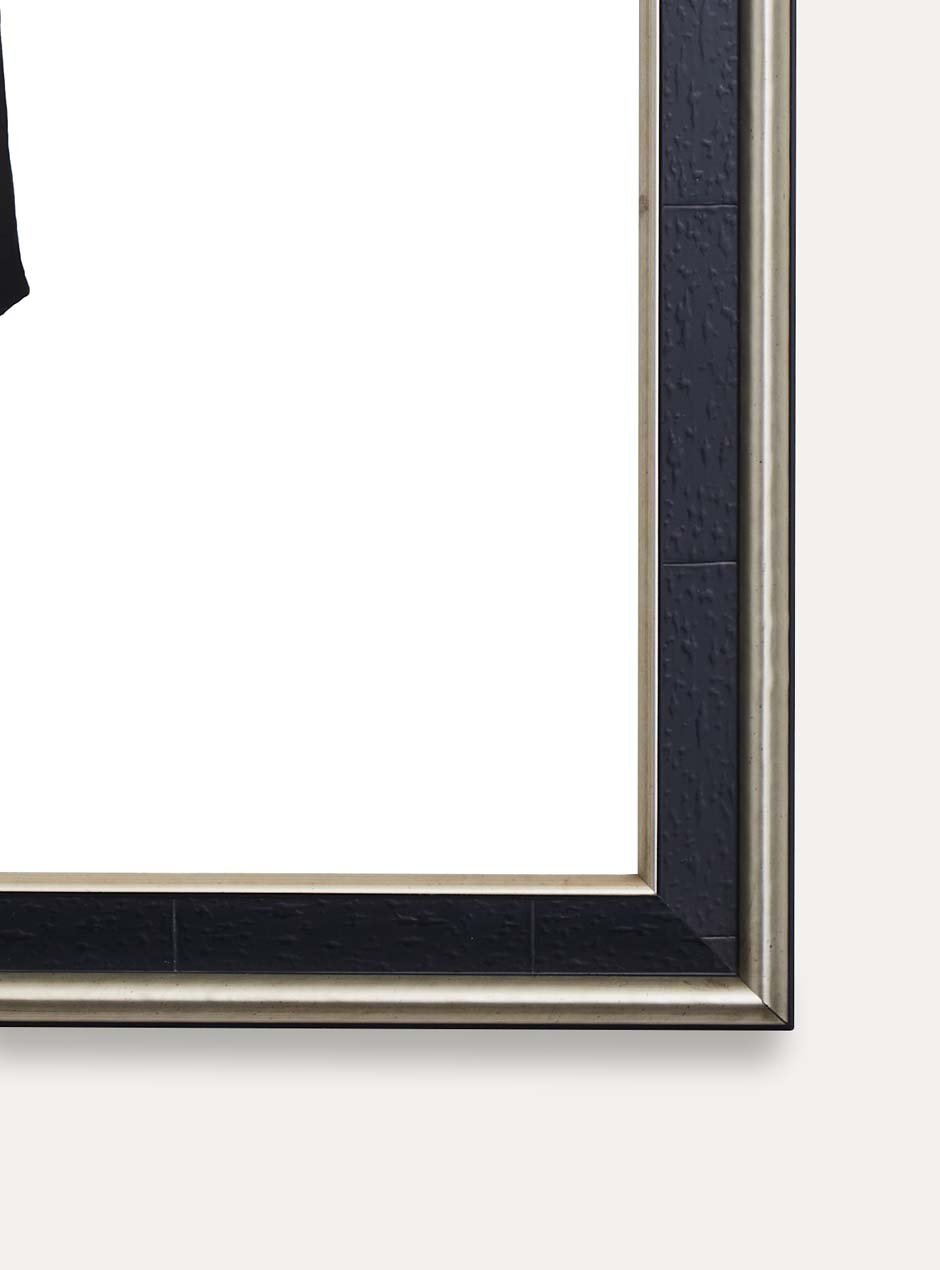 close up of corner of black frame with silver inner and outer detailing