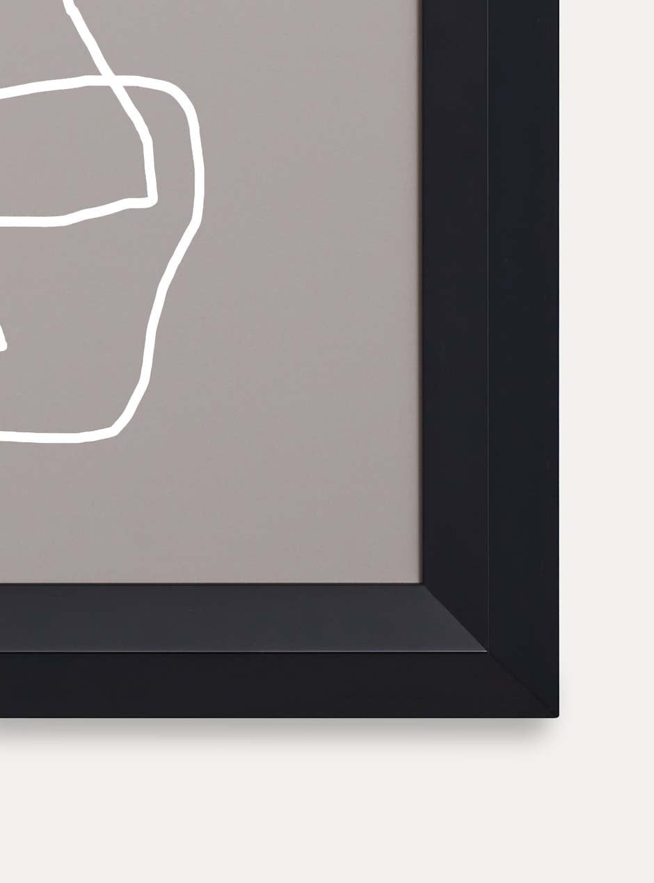 close up of corner of black frame holding abstract art