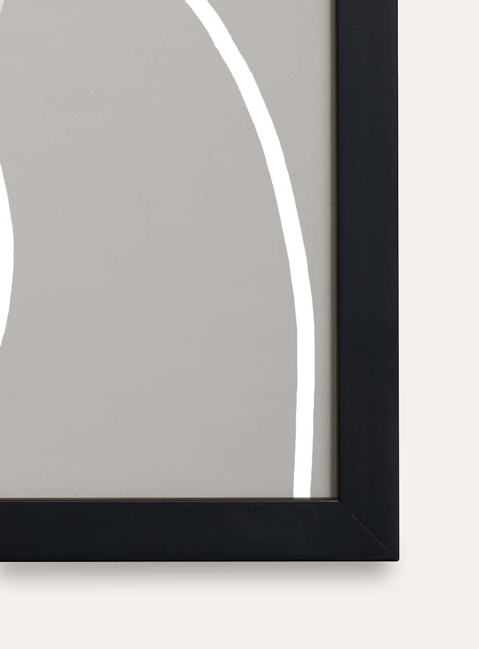 close up of corner of thin black frame holding abstract art