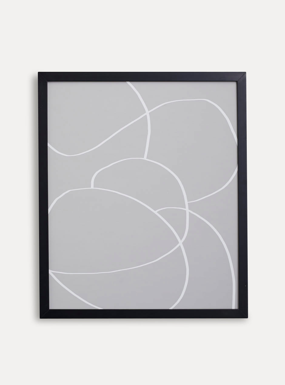 thin black frame holding abstract art