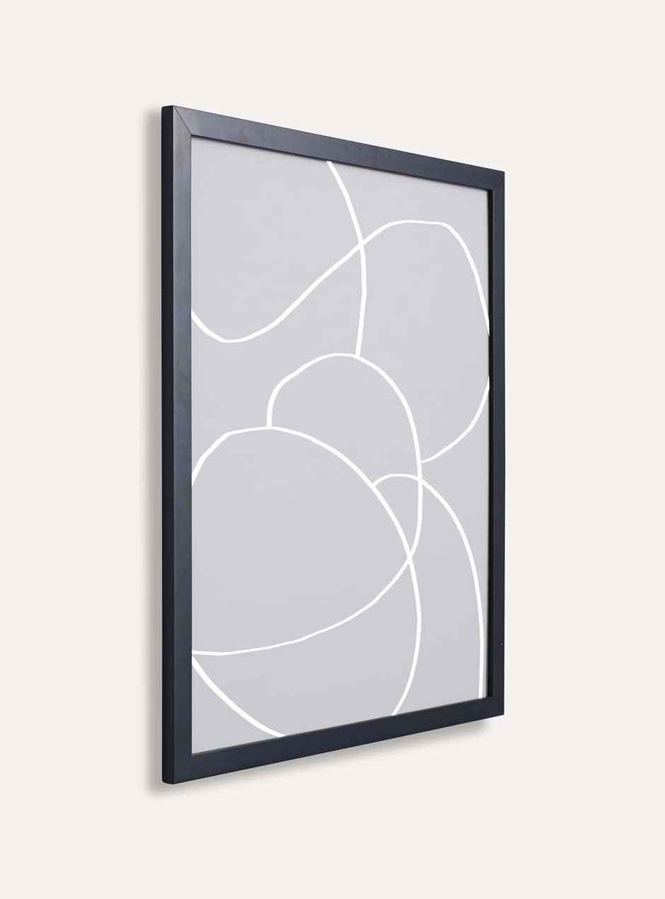 side view of thin black frame holding abstract art