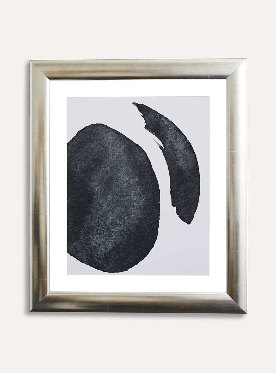 silver frame holding abstract black and white painting 