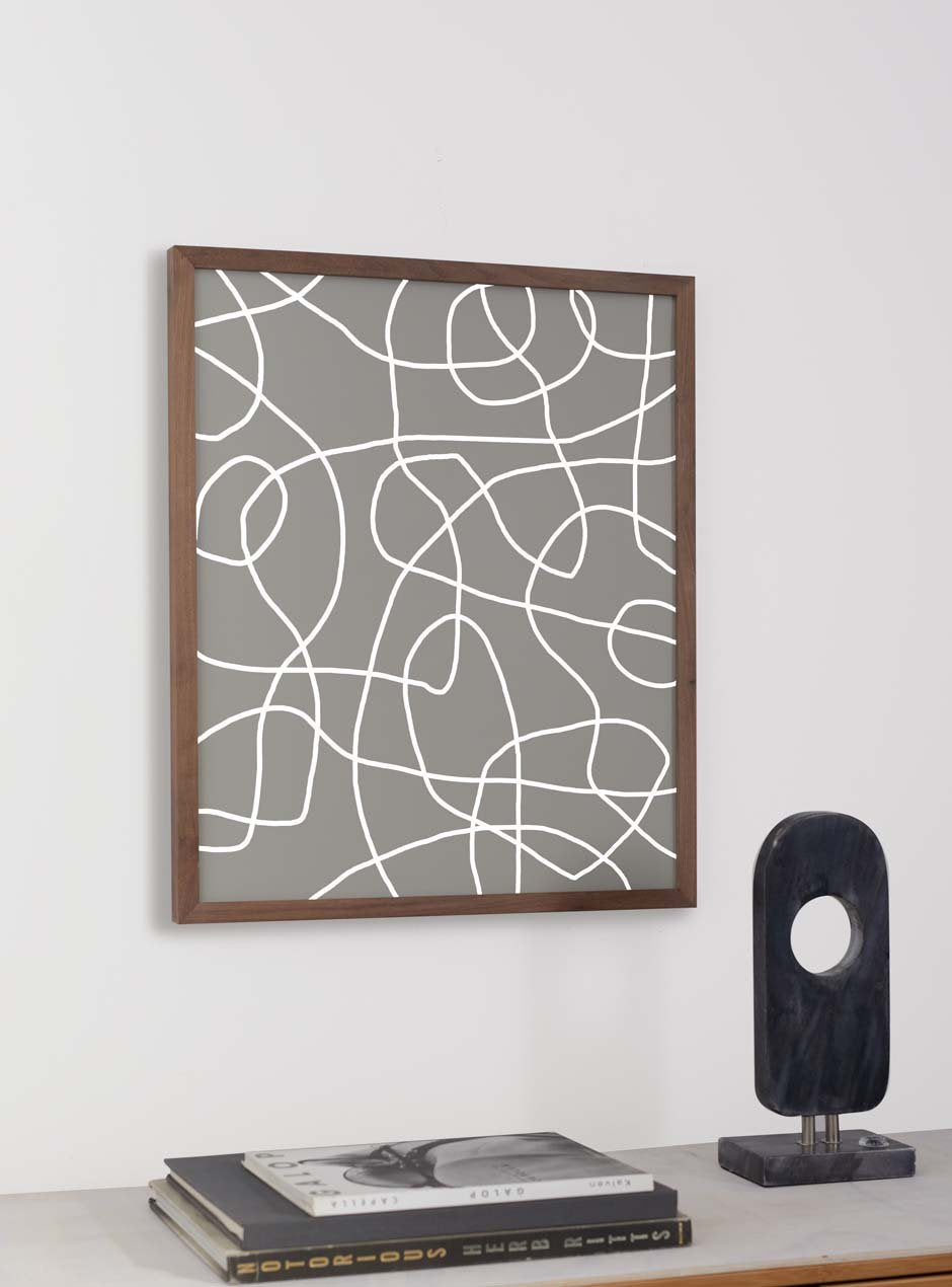 thin brown wooden mirror hung in home